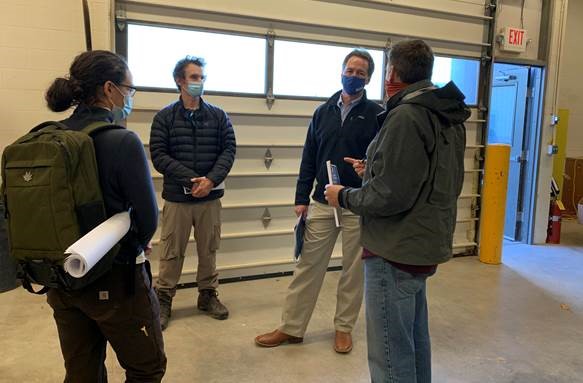 Apprenticeship group of people standing in garage